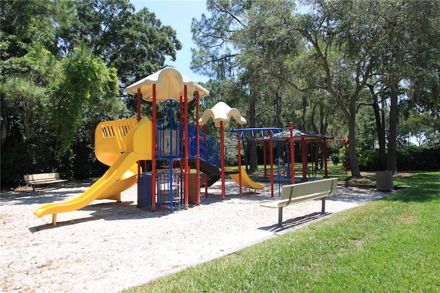 community jungle gym with a lawn