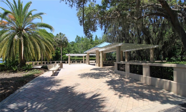 view of community with a patio and a pergola