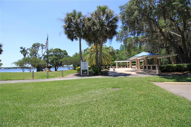 view of community with a water view and a lawn