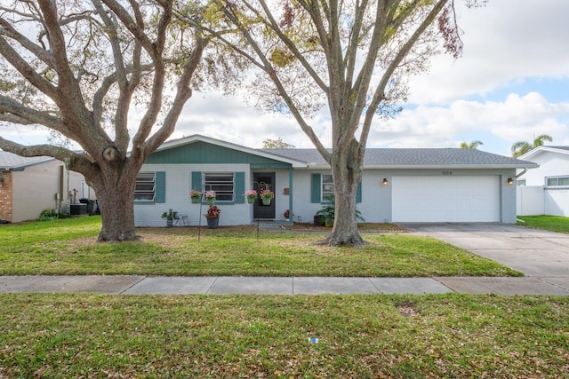 ranch-style house featuring an attached garage, brick siding, and a front yard