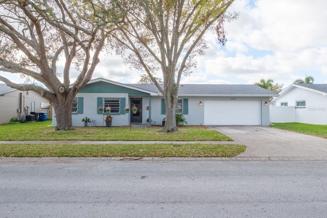 ranch-style house featuring driveway, central AC unit, an attached garage, a front lawn, and brick siding