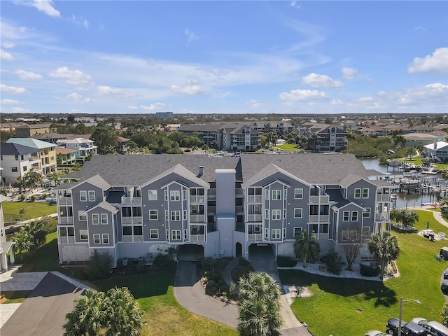 drone / aerial view with a water view and a residential view