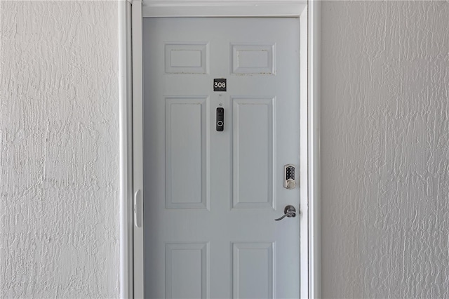 entrance to property featuring stucco siding