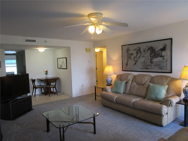 carpeted living area with a ceiling fan and visible vents