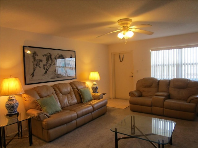 carpeted living room with a ceiling fan