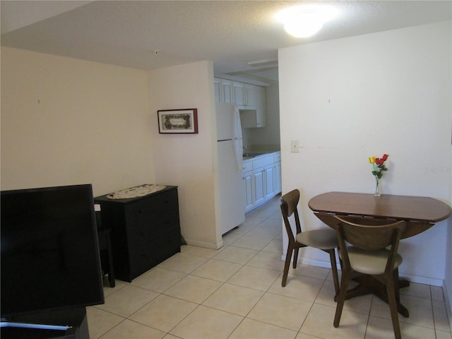 dining area featuring light tile patterned flooring and baseboards