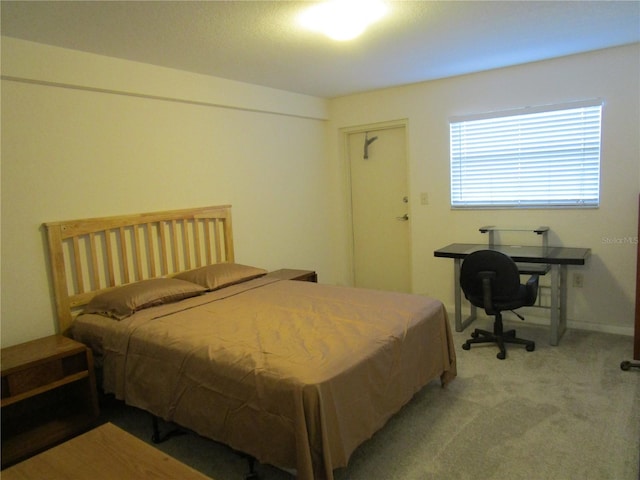 bedroom with carpet flooring and baseboards