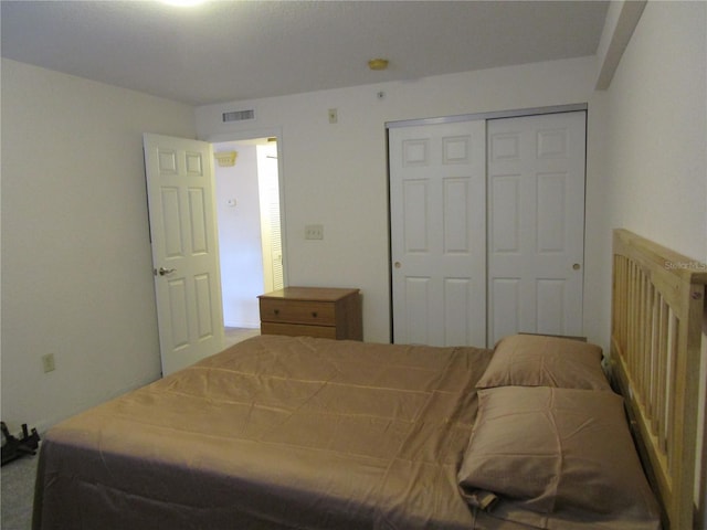 bedroom with a closet and visible vents