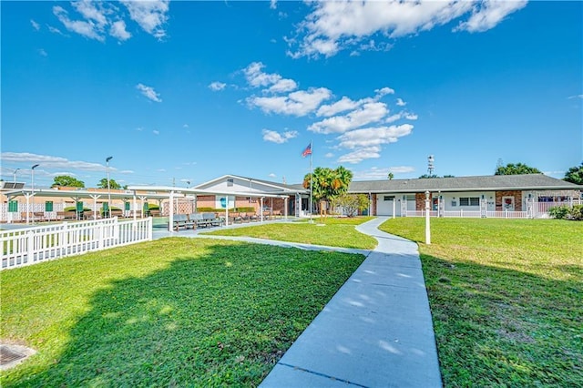 exterior space with fence and a front lawn