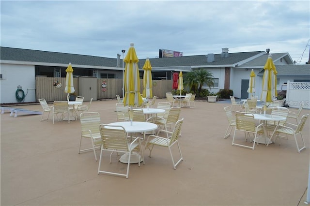 view of patio with outdoor dining area and fence