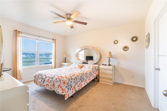bedroom with light carpet, a ceiling fan, and baseboards