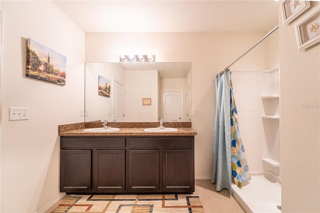 full bath featuring double vanity, a shower stall, a sink, and tile patterned floors