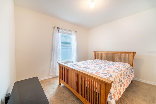 bedroom featuring carpet floors and baseboards