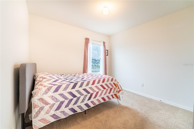 bedroom featuring carpet floors and baseboards