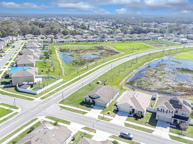 drone / aerial view featuring a water view and a residential view