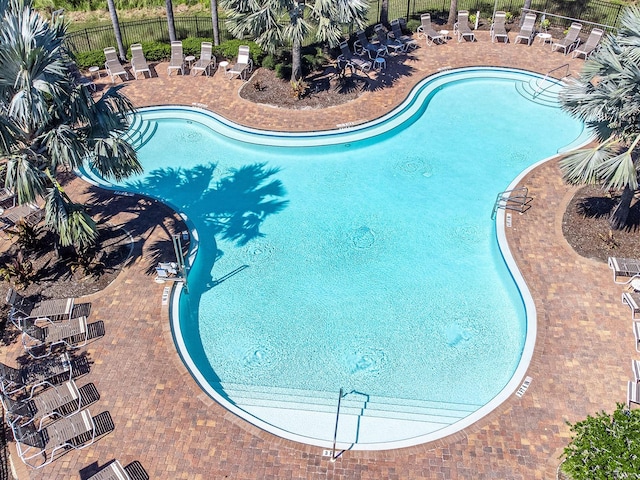 view of pool featuring fence