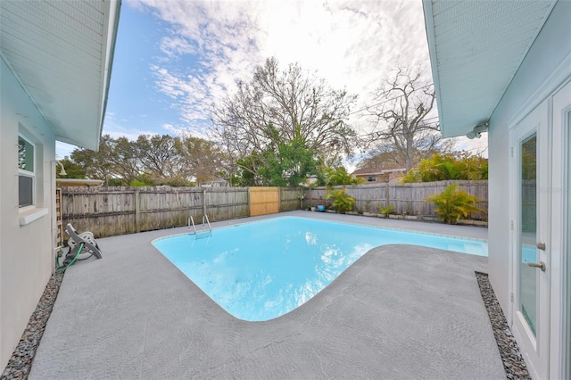 view of swimming pool featuring a fenced in pool, a fenced backyard, and a patio