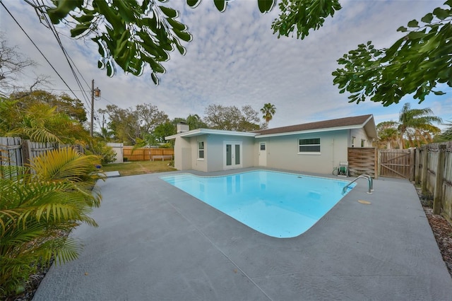 view of swimming pool featuring a fenced in pool, a patio area, a gate, and a fenced backyard