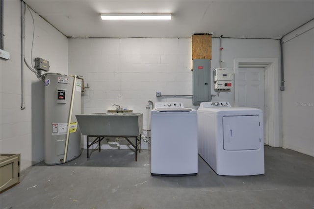 washroom with concrete block wall, washing machine and clothes dryer, water heater, laundry area, and electric panel