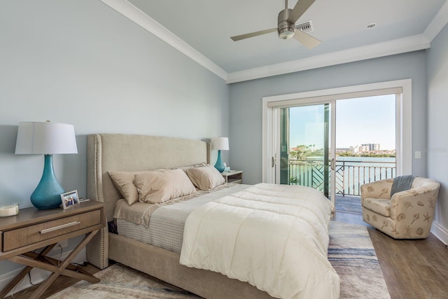 bedroom with a water view, wood finished floors, visible vents, access to exterior, and crown molding