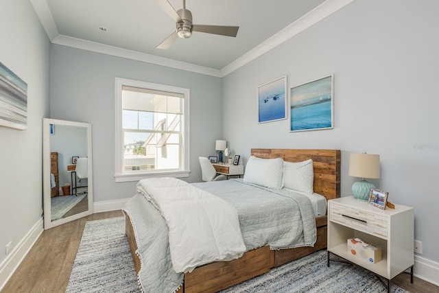 bedroom with ceiling fan, ornamental molding, wood finished floors, and baseboards