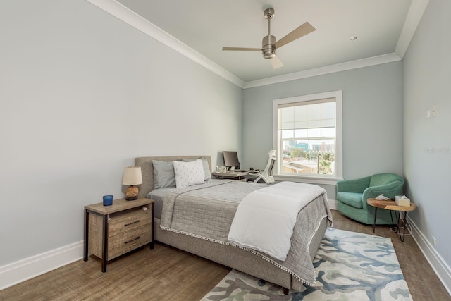 bedroom featuring dark wood-type flooring, crown molding, and baseboards