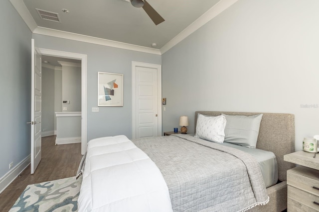 bedroom featuring ornamental molding, dark wood-style flooring, visible vents, and baseboards