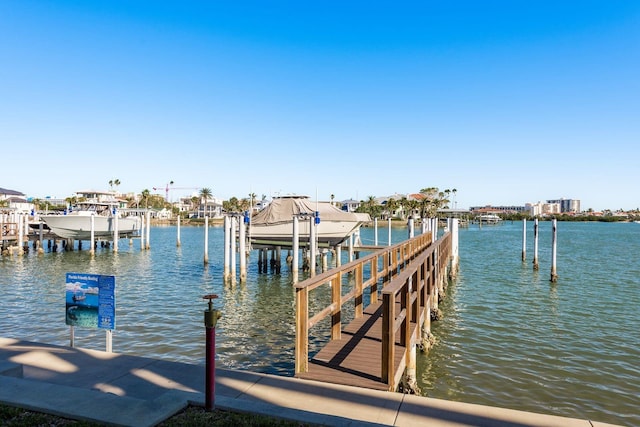 dock area with a water view and boat lift