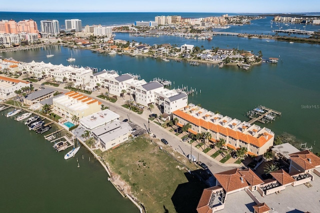 birds eye view of property featuring a water view and a city view