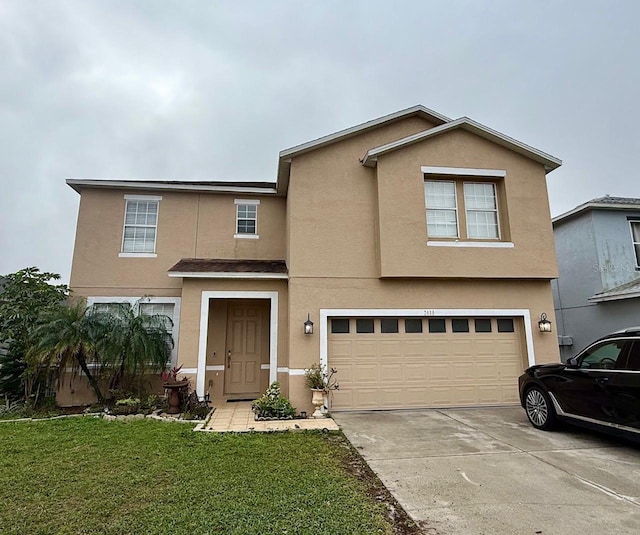 traditional-style house featuring an attached garage, concrete driveway, a front yard, and stucco siding