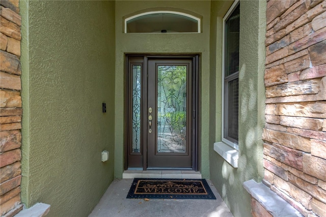 property entrance featuring stucco siding