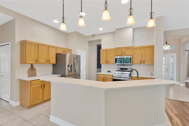 kitchen with a spacious island, stainless steel appliances, light countertops, a towering ceiling, and hanging light fixtures