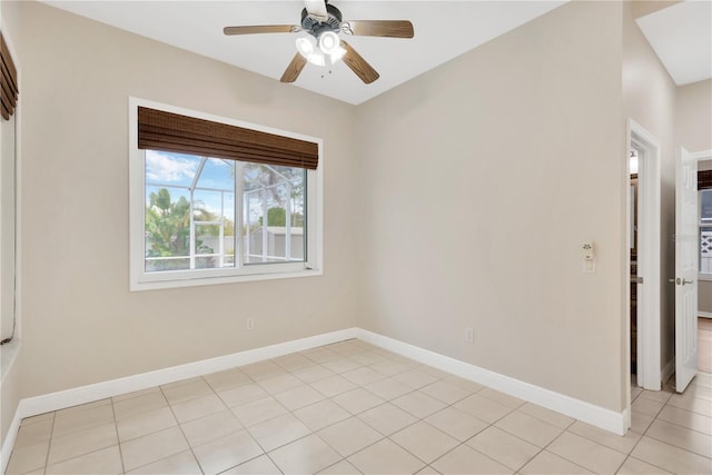 spare room with light tile patterned flooring, baseboards, and ceiling fan