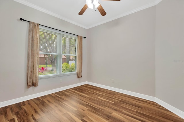 empty room with baseboards, crown molding, ceiling fan, and wood finished floors