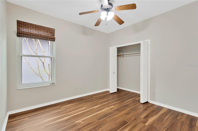 unfurnished bedroom with a closet, baseboards, and wood finished floors