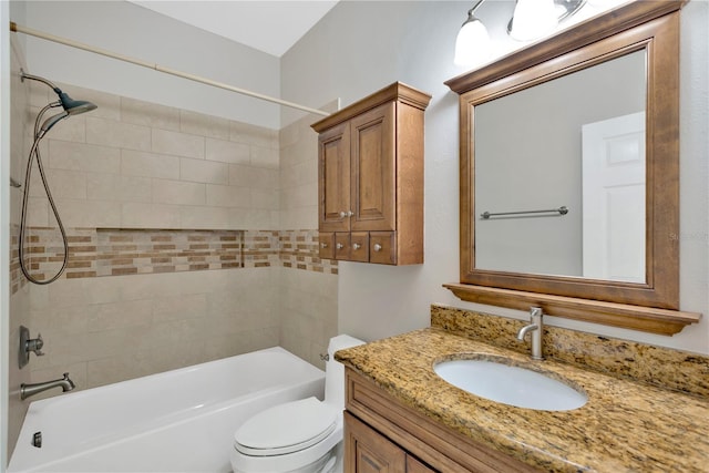 bathroom featuring toilet, vanity, and shower / tub combination