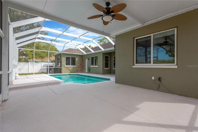 view of swimming pool with a patio area, a fenced in pool, a lanai, and ceiling fan