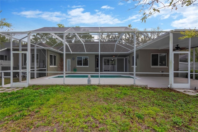 rear view of house featuring an outdoor pool, stucco siding, ceiling fan, and a patio area