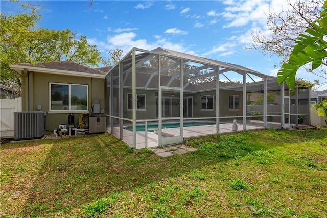 back of house featuring stucco siding, fence, a yard, central AC unit, and a patio area