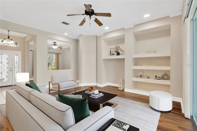 1166 Lumsden Trace Cir, Valrico, FL 33594 - living area with wood finished floors, a ceiling fan, built in features, and recessed lighting