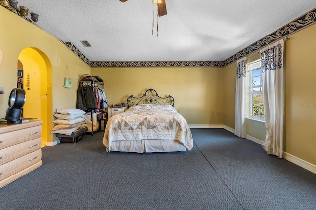 bedroom with a textured ceiling, visible vents, and baseboards