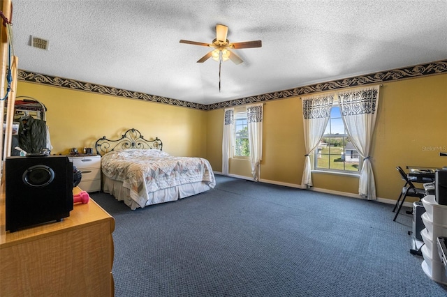 bedroom featuring baseboards, visible vents, a ceiling fan, a textured ceiling, and carpet floors