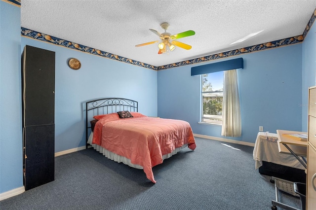 carpeted bedroom with ceiling fan, baseboards, and a textured ceiling