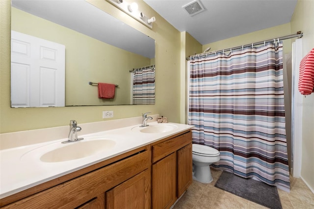 full bathroom featuring toilet, double vanity, a sink, and visible vents