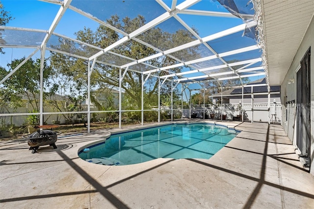 view of pool featuring a fenced in pool, an outdoor fire pit, glass enclosure, and a patio area