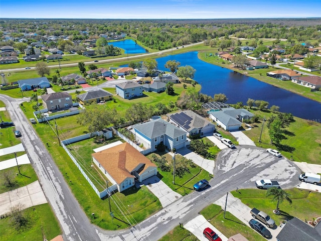 drone / aerial view with a water view and a residential view