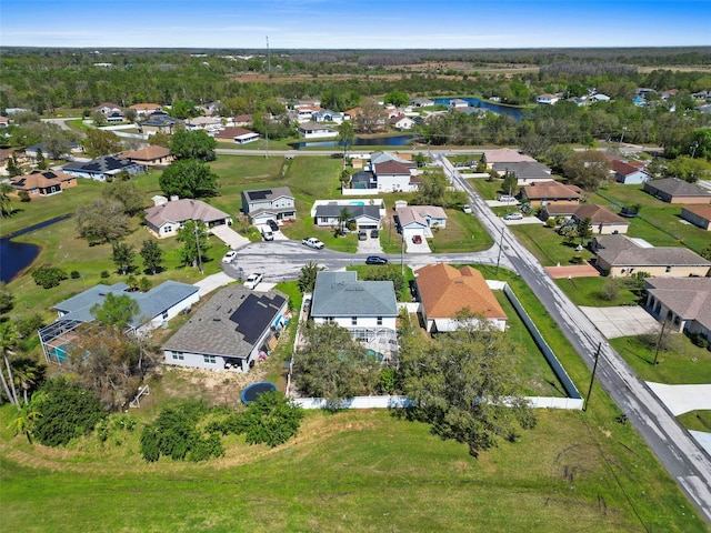 birds eye view of property featuring a water view and a residential view