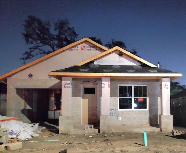 view of front facade featuring concrete block siding