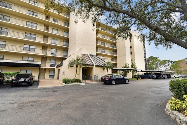 view of building exterior with covered parking