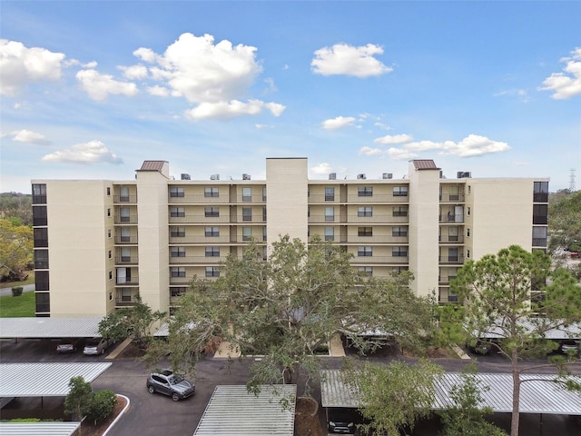 view of building exterior featuring uncovered parking